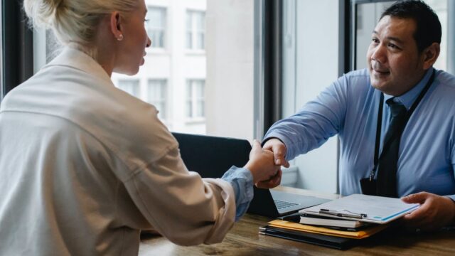 62fe440d954a4525265ce2d4_Candidate and employer shaking hands in an interview